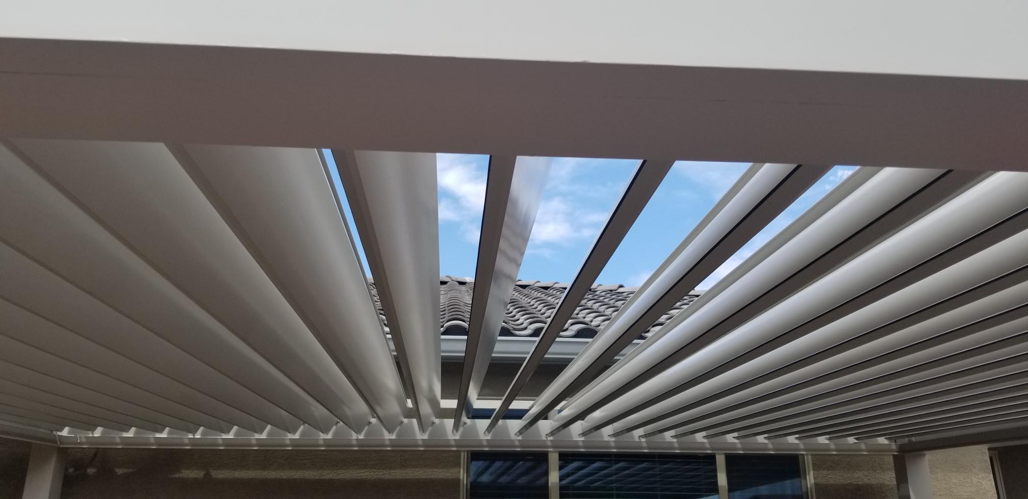 Looking up through open Sundance louvers at blue sky