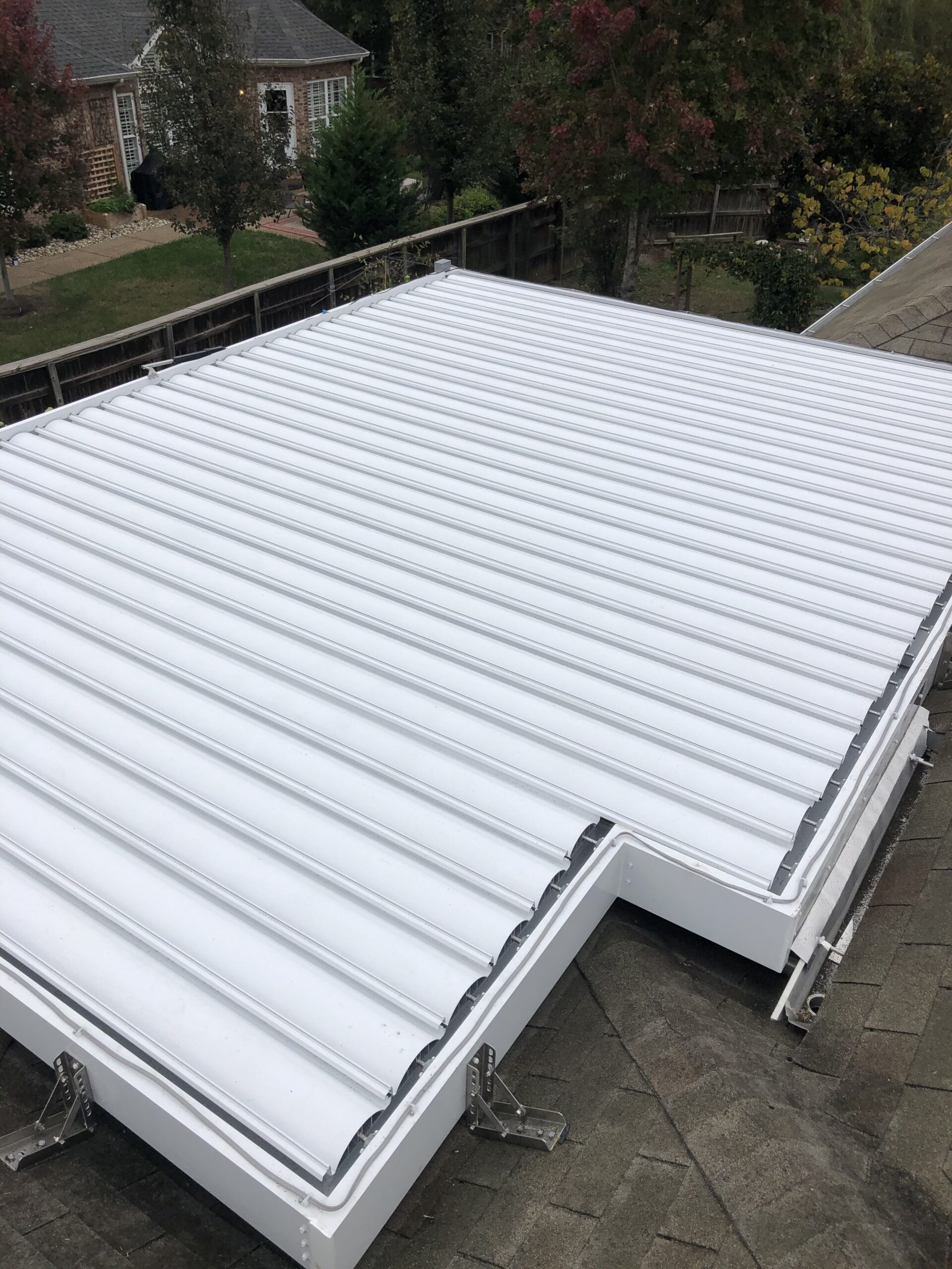 All-white Sundance louvered pergola on roof mounts viewed from above