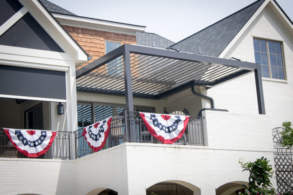 picture of bronze sundance louvered pergola with tan louvers and rainier powered screens on covered patio with fixed screens in arches