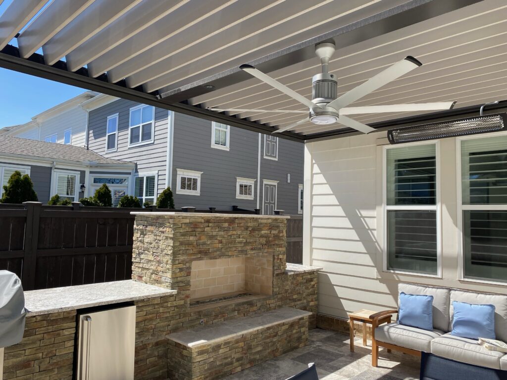 picture of bronze sundance louvered pergola with tan louver with a fan beam and bromic heater attached