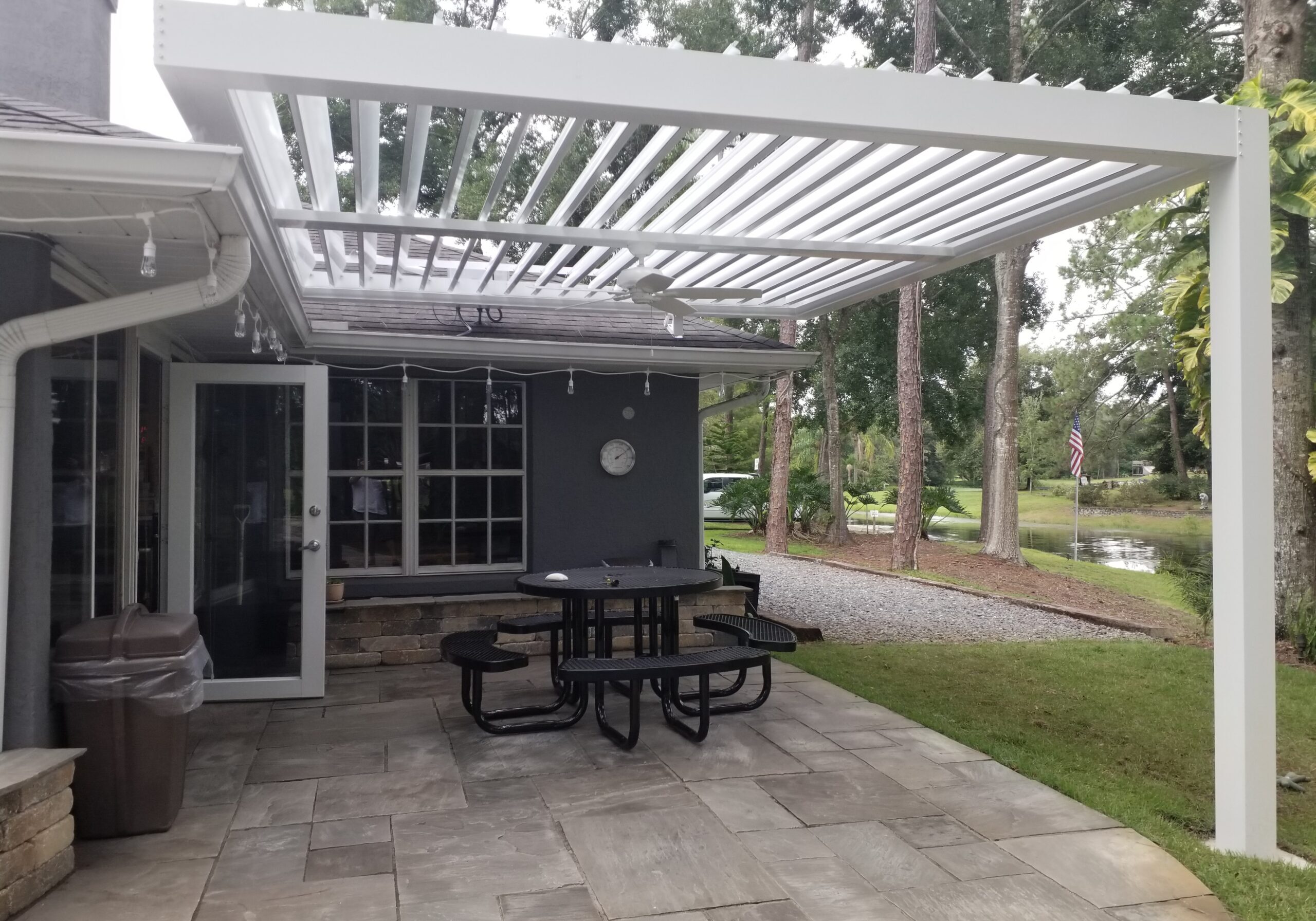 picture of white sundance louvered pergola with white louvers open and fane beam