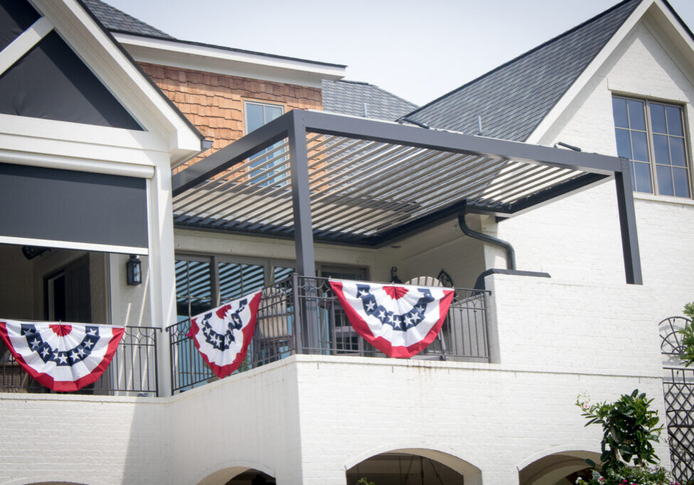 Bronze Sundance louvered pergola with Rainier powered screens on a covered patio