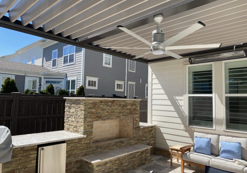 Bronze Sundance louvered pergola with tan louvers, fan beam and Bromic heater